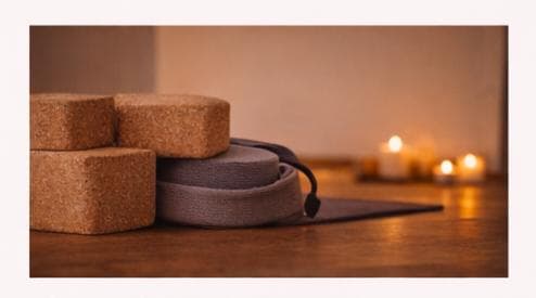 Yoga blocks and props in candlelight