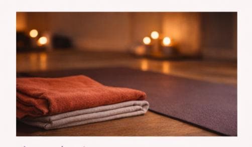 Folded towels beside a yoga mat